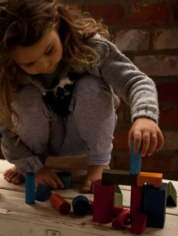 Niña jugando con bloques de colores